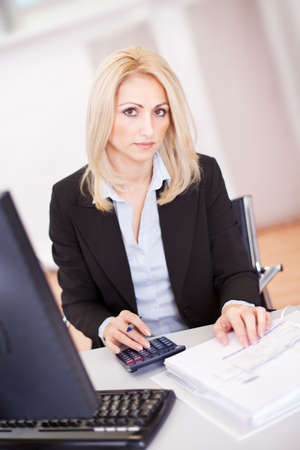 Beautiful businesswoman doing finances in the officeの写真素材