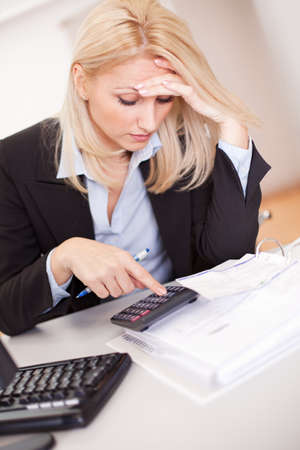 Beautiful businesswoman doing finances in the officeの写真素材