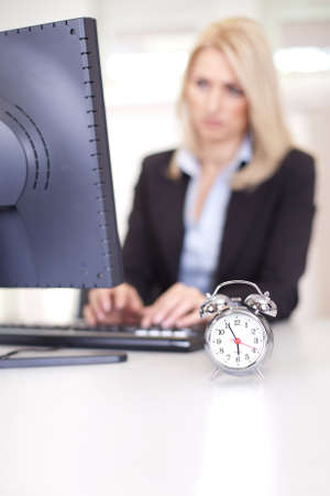 Beautiful businesswoman trying to meet a deadline in the officeの写真素材