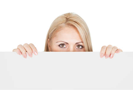 Cheerful businesswomen presenting empty board. Isolated on whiteの写真素材