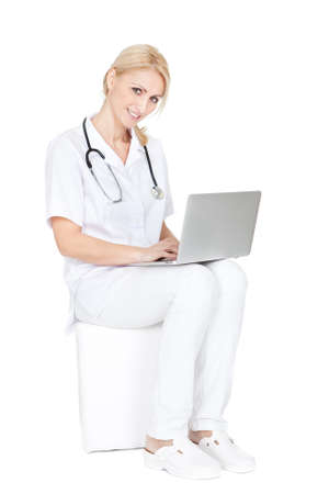 Medical doctor working on laptop. Isolated on whiteの写真素材