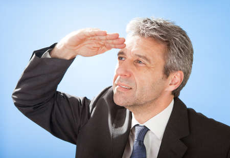 Portrait of successful senior businessman on skyの写真素材