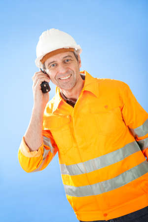 Portrait of senior construction worker talking on radioの写真素材