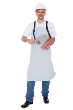 Portrait of smiling bricklayer. Isolated on whiteの写真素材