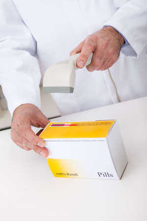 Pharmacist scanning barcode using scanner at drugstoreの写真素材