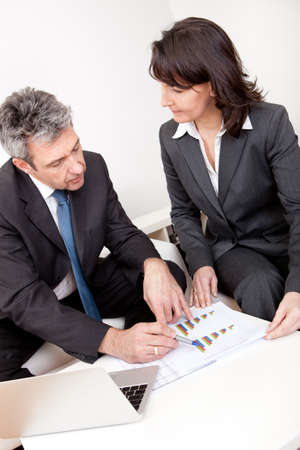 Two business people sitting in the couch discussingの写真素材