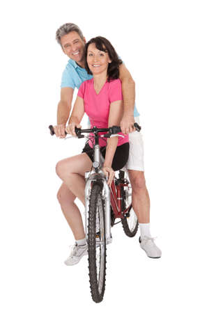 Mature active couple doing sports. Isolated on whiteの写真素材