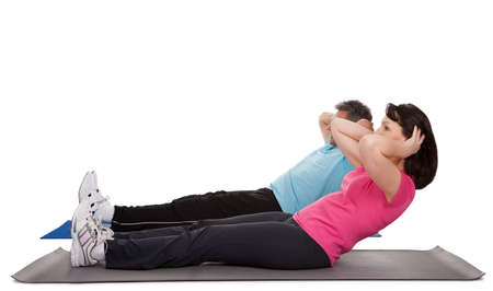 Active mature couple doing fitness. Isolated on whiteの写真素材