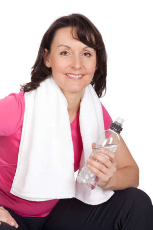 Active mature woman doing fitness. Isolated on whiteの写真素材