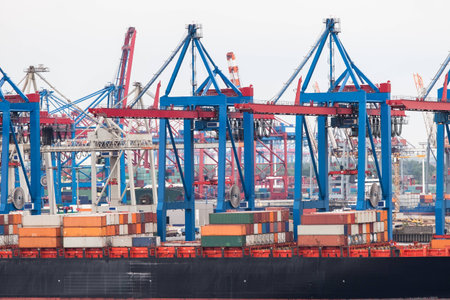 Huge container ship fully loaded in port terminal