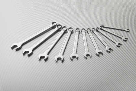 Metallic wrench tool set on metal background