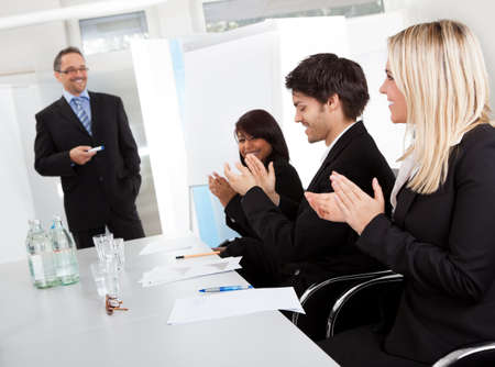 Group of business people at presentation applauding to the lecturerの写真素材