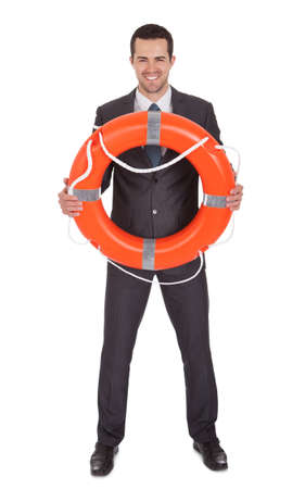 Young businessman with life buoy. Isolated on whiteの写真素材