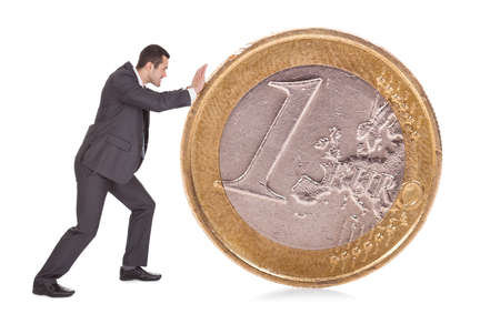 Successful businessman pushing one euro coin. Isolated on whiteの写真素材