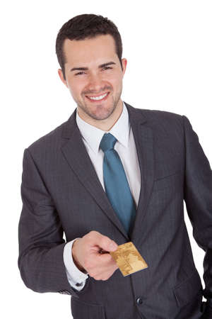 Successful businessman holding credit card. Isolated on whiteの写真素材