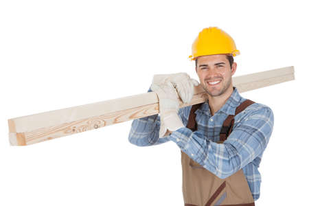 Worker wearing hard hat and carrying timber. Isolated on whiteの写真素材