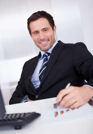 Portrait Of Happy Businessman At Workplace In the Officeの写真素材