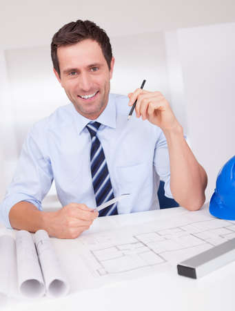 Portrait Of Architect With Blueprint In The Officeの写真素材