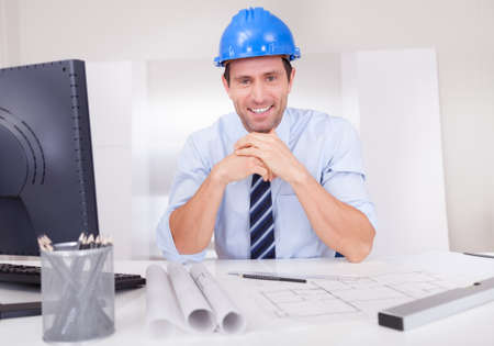 Portrait Of Architect With Blueprint In The Officeの写真素材
