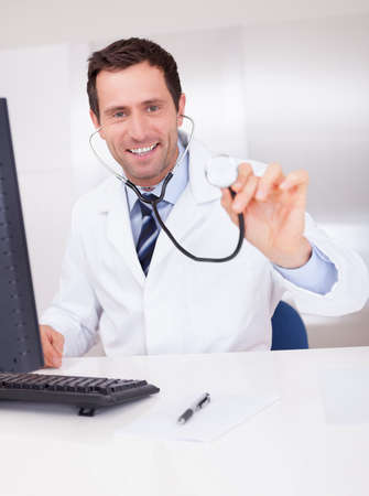 Portrait Of Male Doctor Holding A Stethoscope For Medical Checkupの写真素材