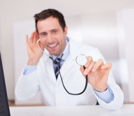 Portrait Of Male Doctor Holding A Stethoscope For Medical Checkupの写真素材