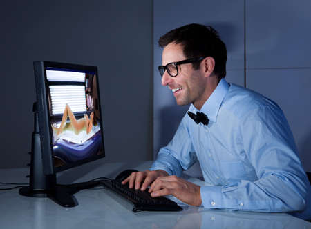 Portrait Of Happy Businessman Looking At Sexy Woman In Computerの写真素材