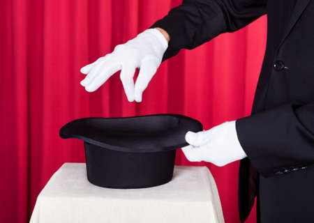 Close-up Of A Magician Performing Magic With Hatの写真素材