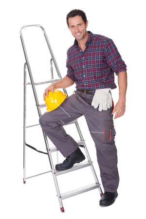 Young Worker Man With Hard Hat Leaning On Ladderの写真素材