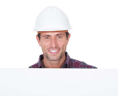 Man Wearing Hard Hat Holding Placard On White Background