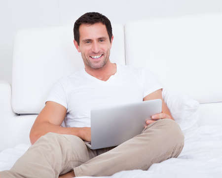Portrait Of Young Man With Laptop, Indoorsの写真素材