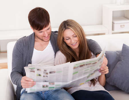 Both read recent article dealing relationships from newspaper.の写真素材