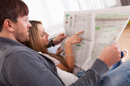 Both read recent article dealing relationships from newspaper.の写真素材