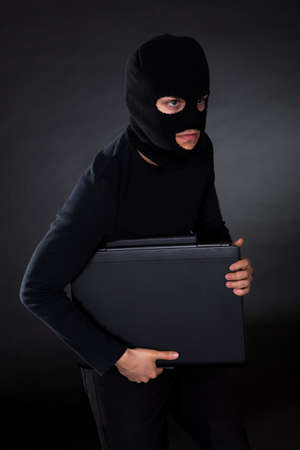 Hacker in disguise stealing data from Computerの写真素材