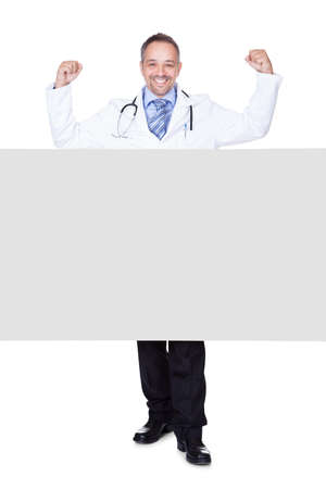 Portrait Of A Doctor Holding Blank Placard Isolated On White Backgroundの写真素材