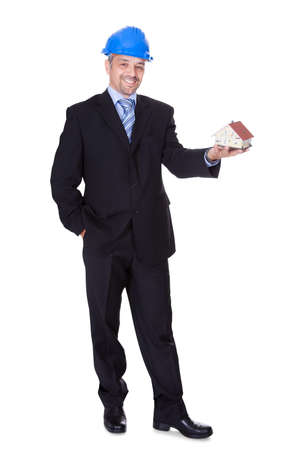 Happy Male Architect Holding Model House On White Backgroundの写真素材