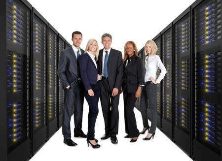 Businessteam standing on front of two lines of server racks. Isolated on white background