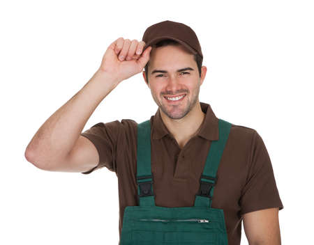 Happy young gardener in dungarees. Isolated on white