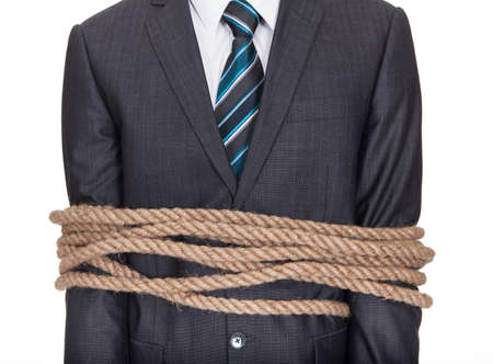 Businessman tied up in rope. Isolated on whiteの写真素材