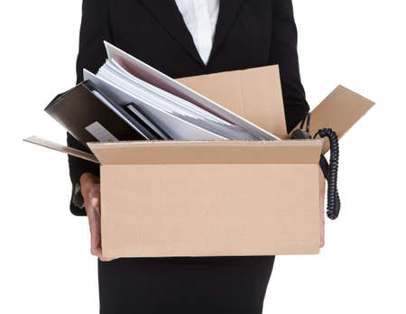 Young Business Woman Holding A Box Of Documents. Isolated On Whiteの写真素材