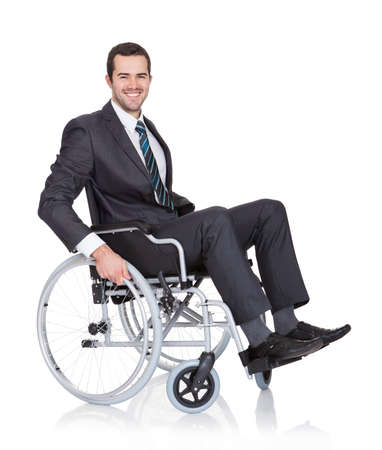 Young businessman in wheelchair. Isolated on whiteの写真素材