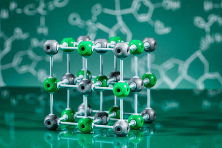 Model of molecular structure on green reflective backgroundの写真素材