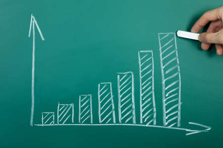 Hand drawing growth chart on green chalkboardの写真素材