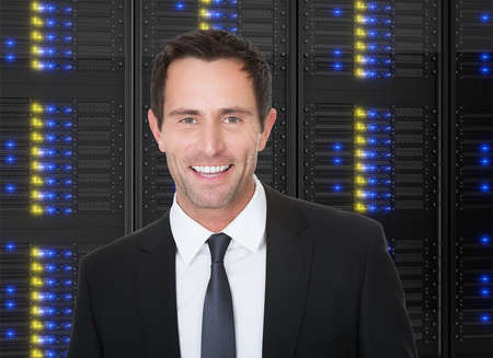 Photos of businessman standing in front of server racksの写真素材