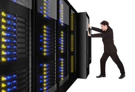 Businessman pushing server rack in place. Isolated on white
