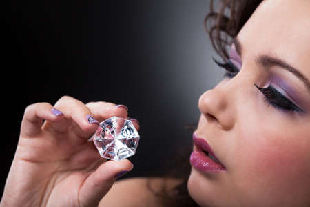 Portrait Of Young Beautiful Woman Holding Diamondsの写真素材