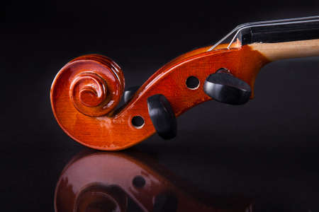 Close-up Of Vintage Violin Over Black Backgroundの写真素材