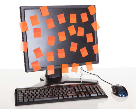 Computer screen covered in sticky notes. Isolated on whiteの写真素材