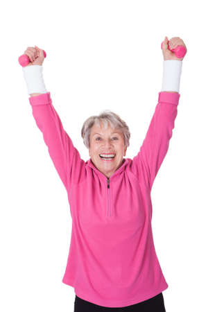 Portrait Of A Senior Woman Exercising On White Backgroundの写真素材