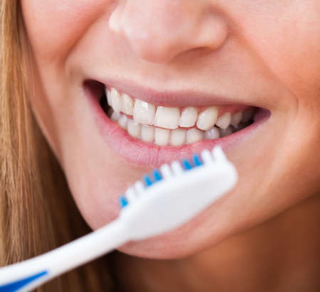 Close-up Of A Woman Brushing Her Teeth