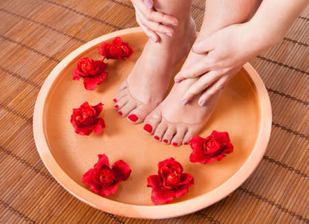Close-up Of Female Feet Getting Spa Aroma Therapyの写真素材